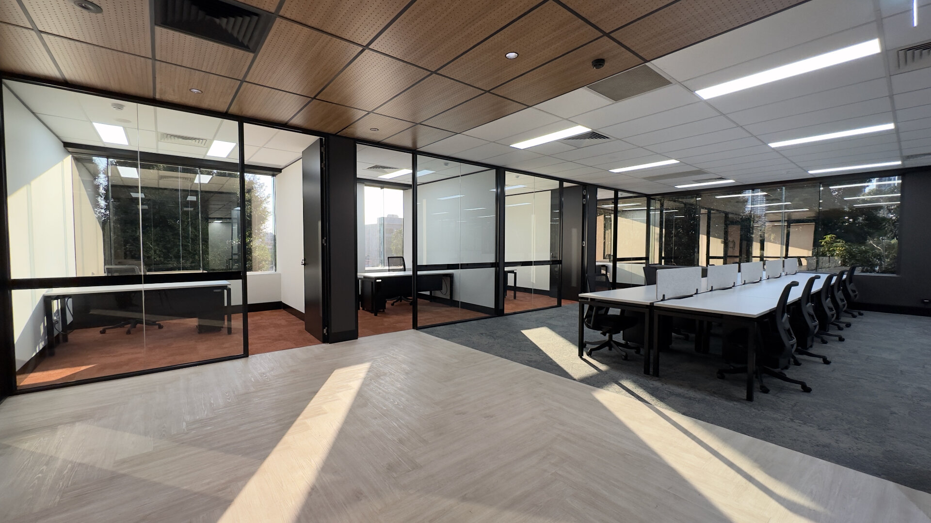 Commercial office ceiling tile replacement showing timber acoustic panels and white suspended grid with LED lighting in Melbourne