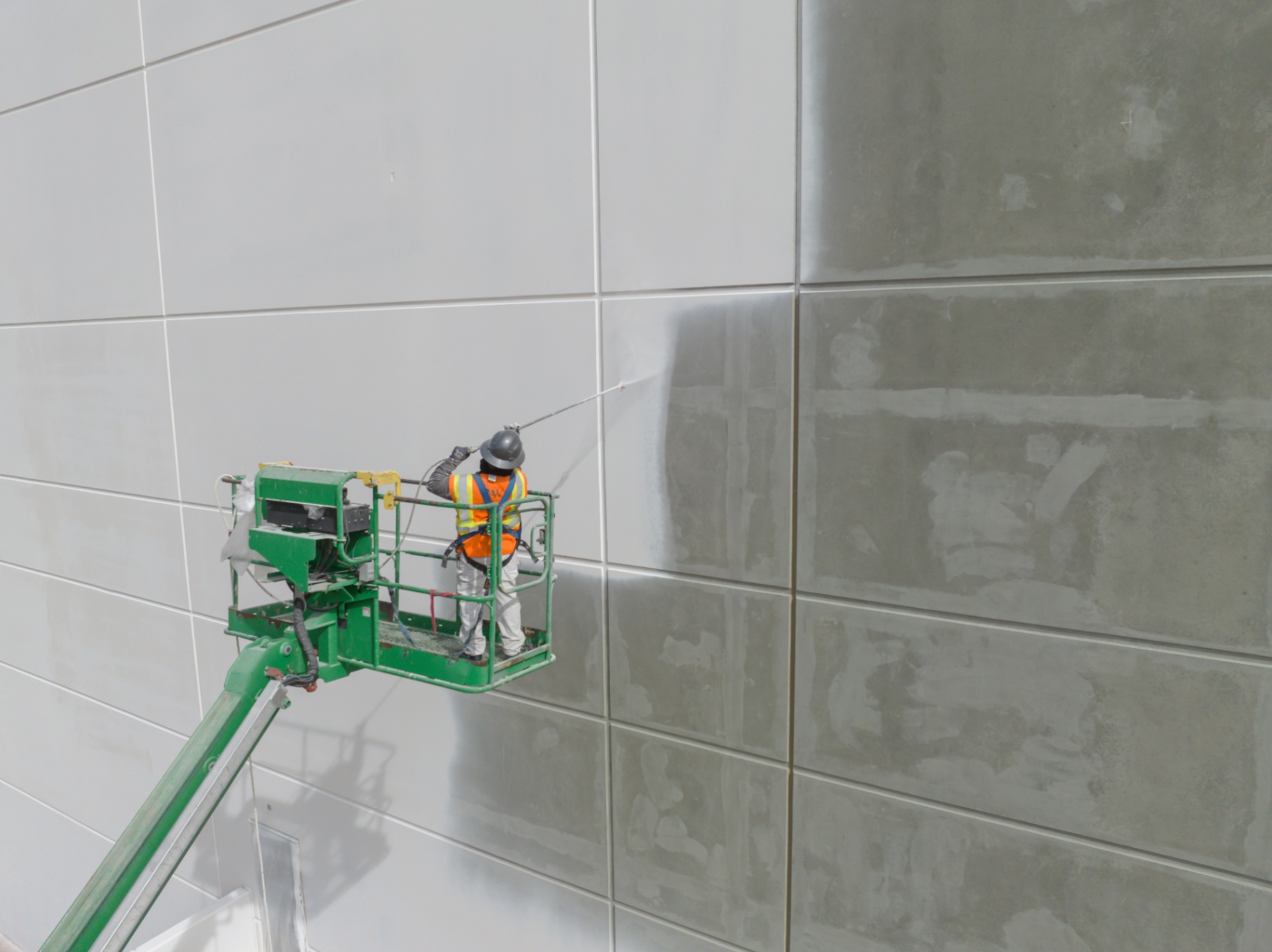 Commercial building facade painting using cherry picker access equipment for exterior panel surfaces in Melbourne