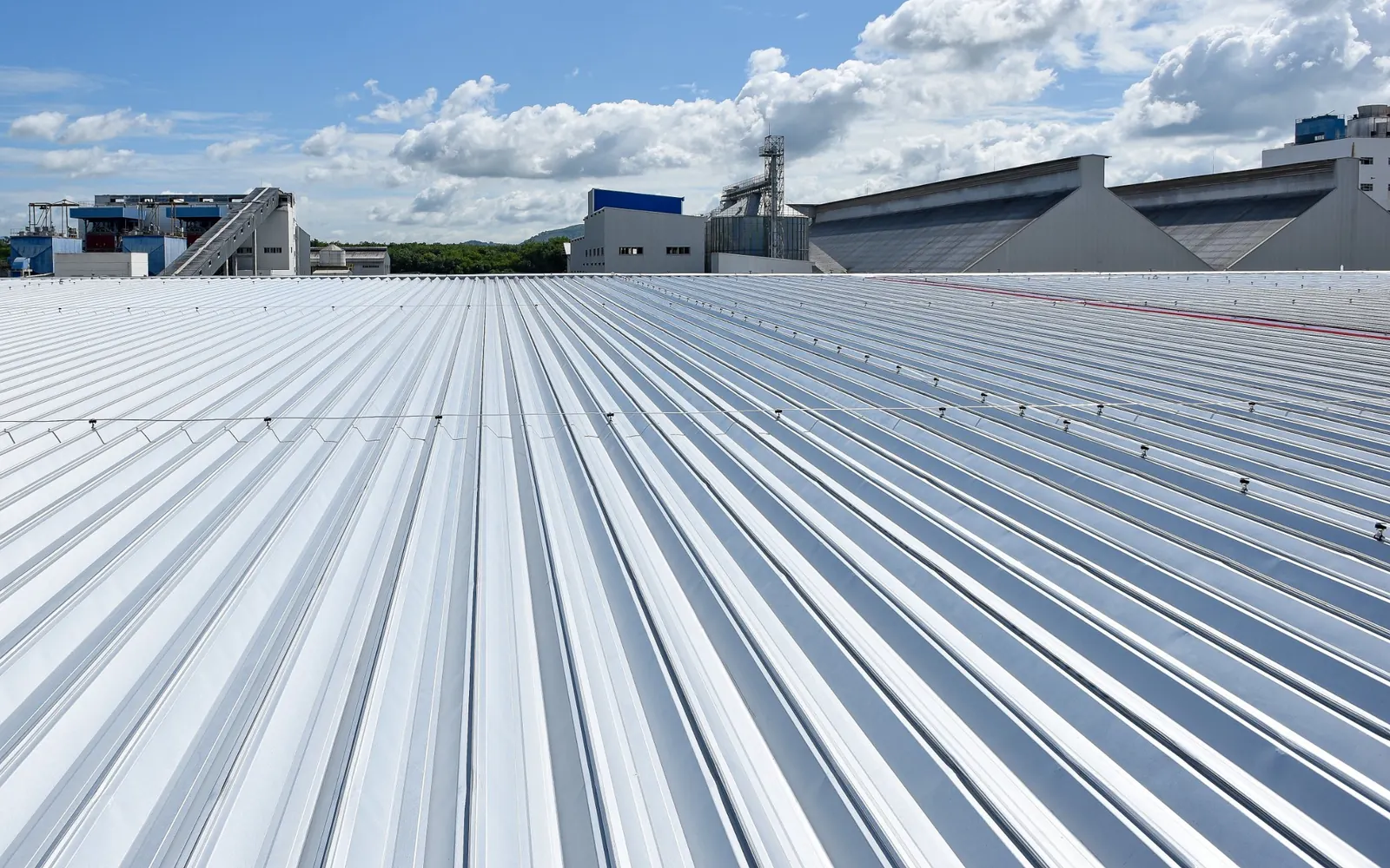 New metal deck roof sheeting across a large industrial warehouse roof