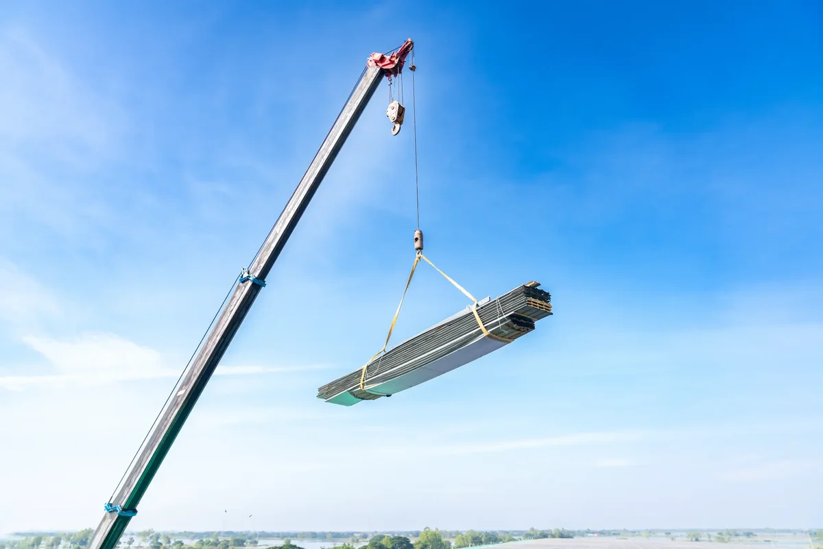 Crane lifting polycarbonate roof panels for industrial skylight installation Melbourne
