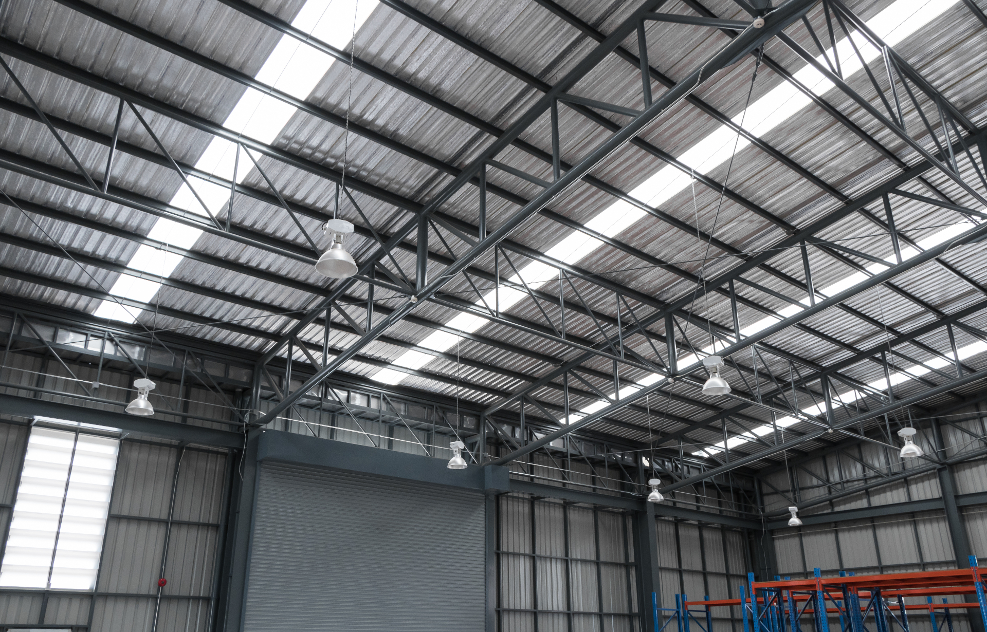 Industrial factory roof structure with steel trusses and pallet racking in Melbourne warehouse