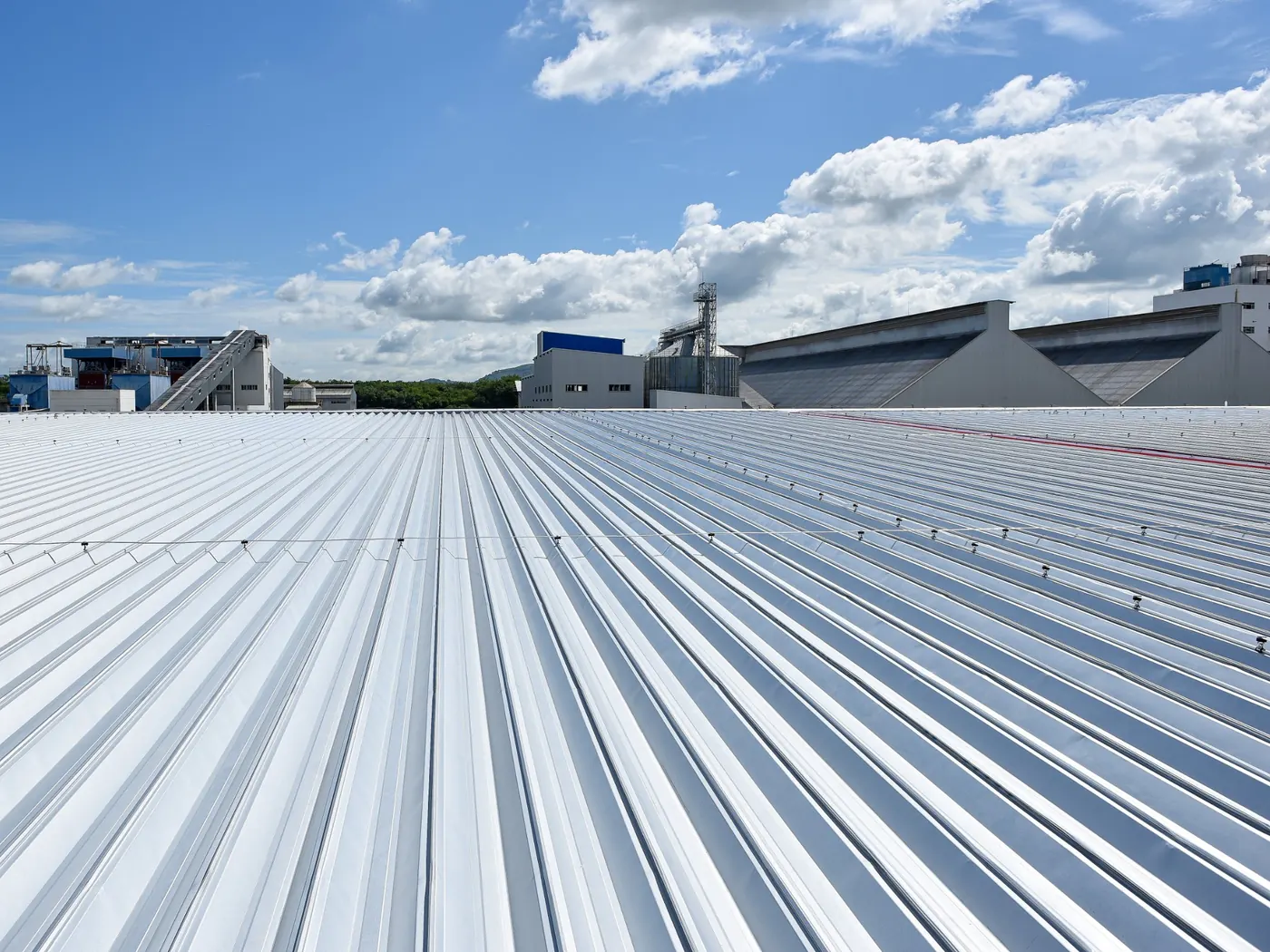 New metal deck roof sheeting across a large industrial warehouse roof