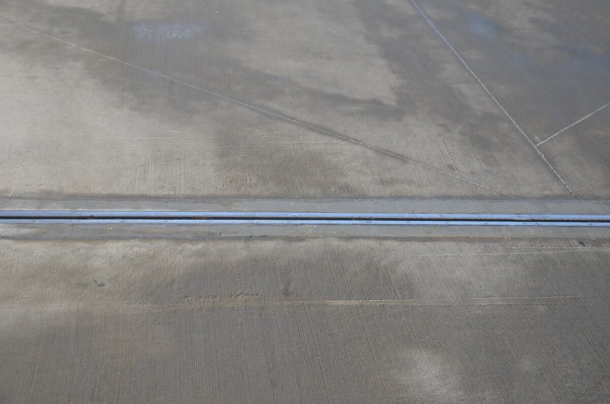 Close-up of concrete floor expansion joint showing repair work on industrial warehouse floor Melbourne