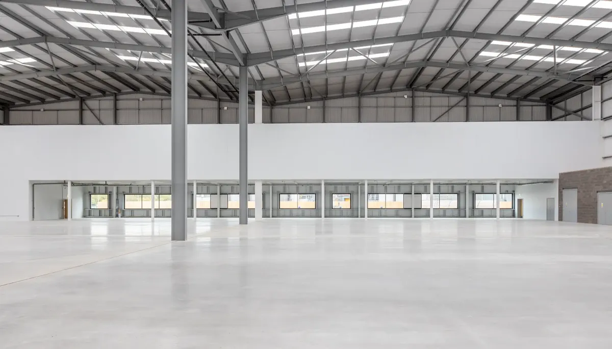 Empty industrial warehouse interior with steel frame structure and polished concrete floor ready for make good handover in Melbourne
