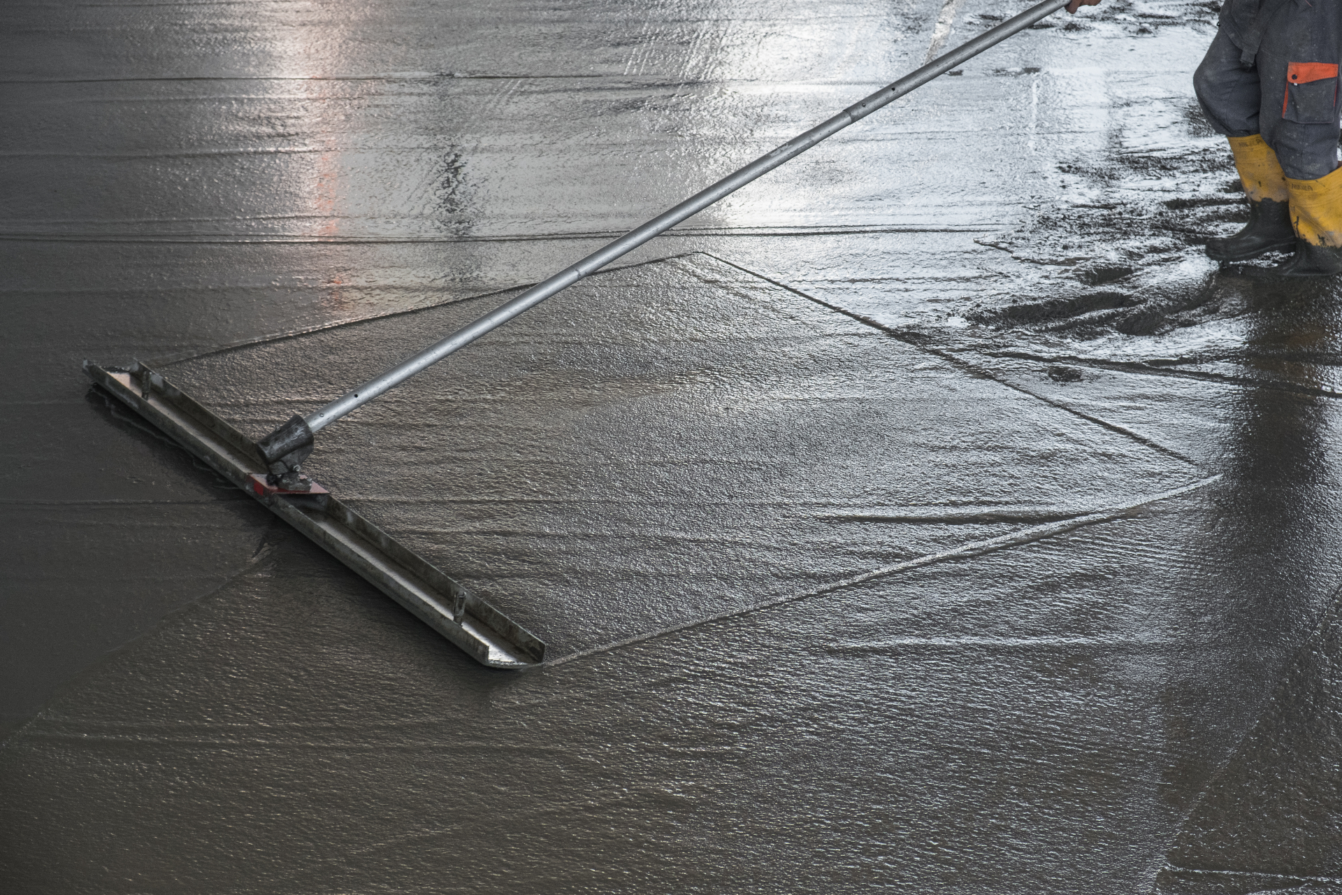 Concrete floor leveling with screed tool for warehouse floor repairs Melbourne