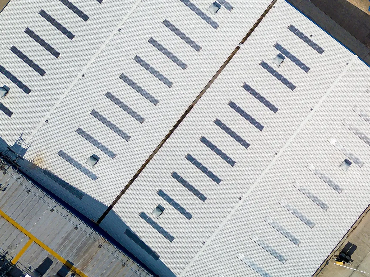 Aerial view of commercial warehouse metal roofs with rows of skylights, Melbourne